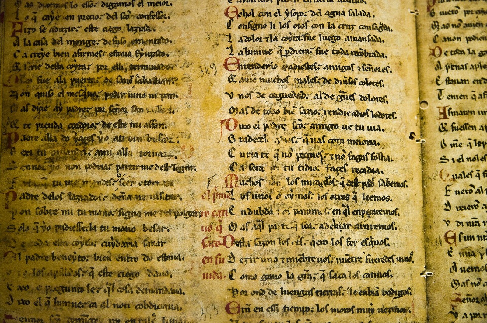 An illuminated manuscript page, ink laid down in bands of colour by hand.